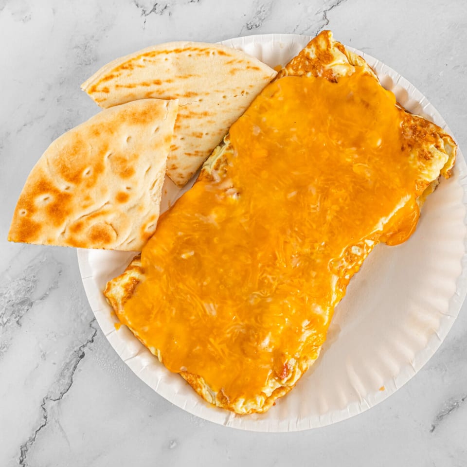 A cheesy omelet and two pieces of flatbread on a white paper plate.